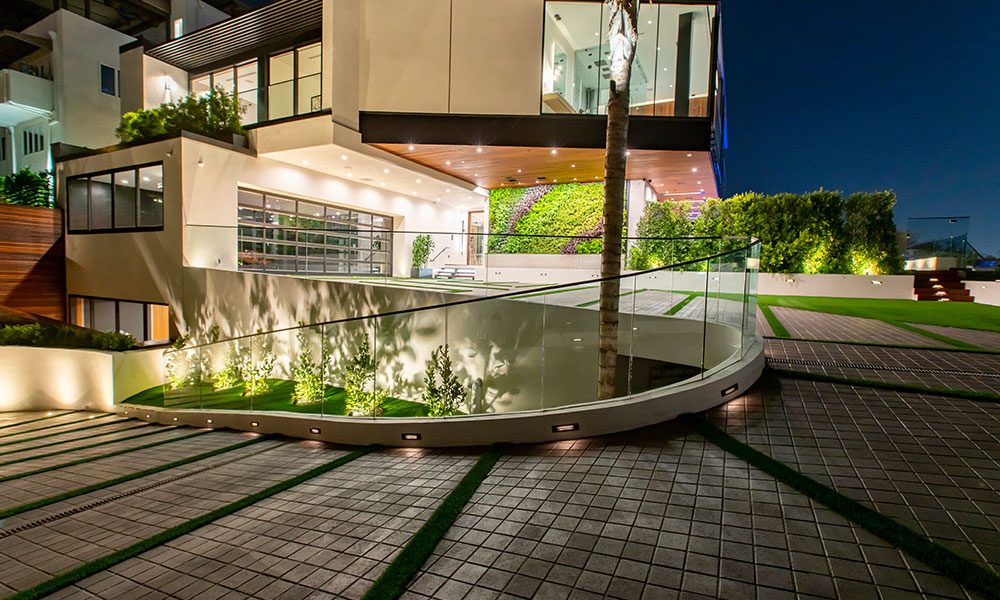 Main driveway of a smart home lit at night