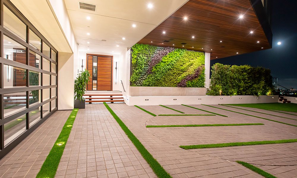 Front entry of a modern home with living green wall and integrated lighting