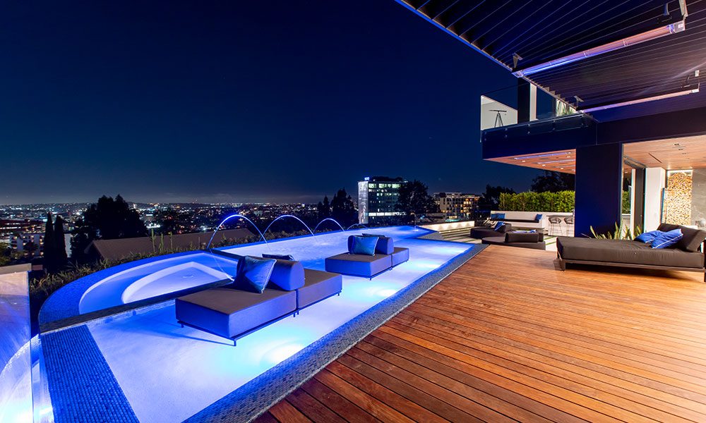 Backyard pool lit at night