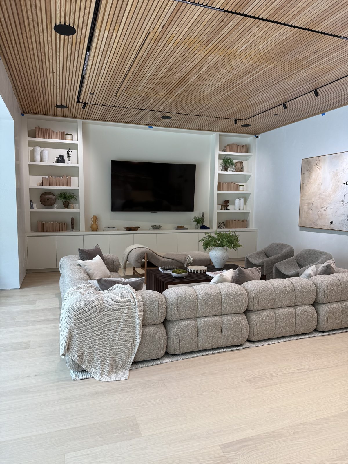 Family room with slatted wood ceiling and built-in TV