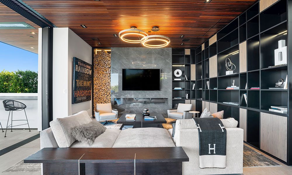 Living room with integrated TV wall and statement lighting